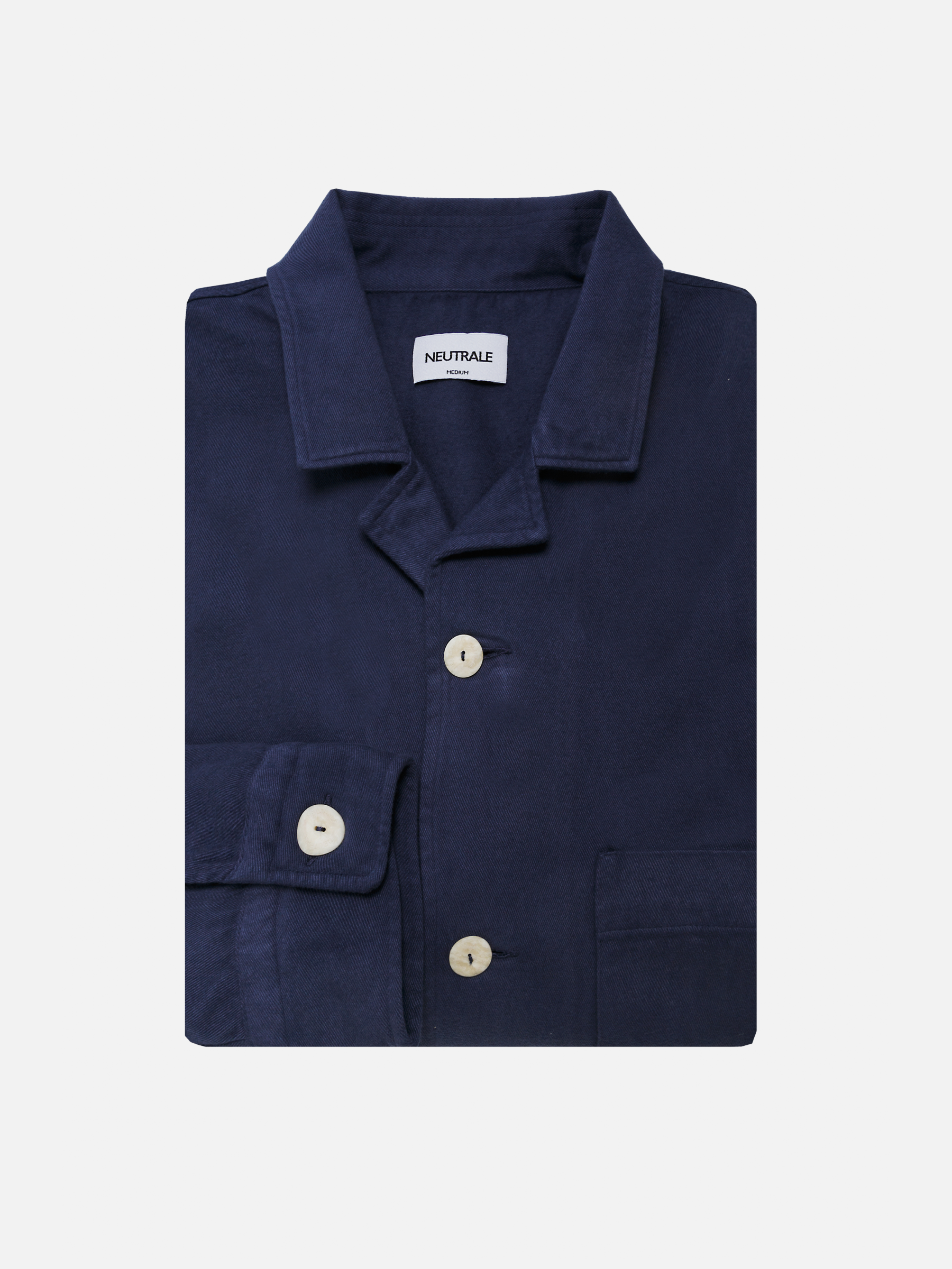 French navy unisex overshirt & loose-fitting with a classic button-down front and round hem. Crafted from 100% certified organic cotton.